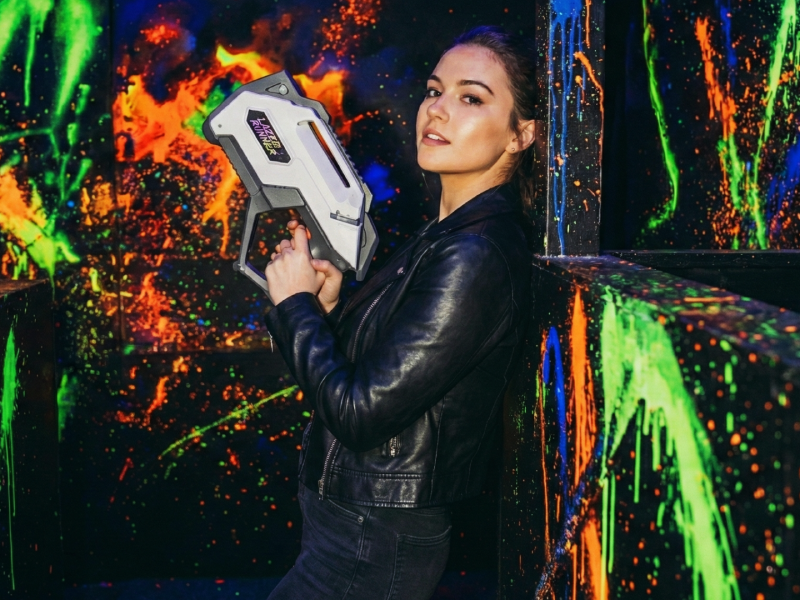 Neon-lit laser tag arena with blue and red lights