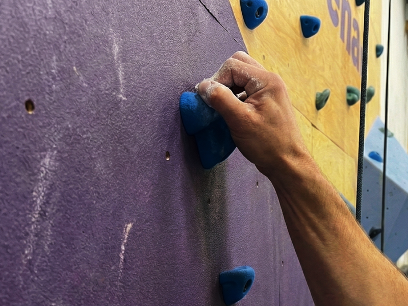 Three friends rock climbing and playing mini golf